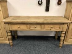 A reclaimed pine kitchen dresser fitted with three drawers,