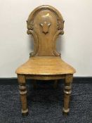 An Edwardian oak shield back hall chair