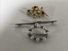Three gold brooches, all variously set with pearls, 11.