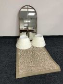 A teak arched topped mirror, pair of table lamps,