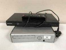 A Samsung 3D blu ray player with remote and a Xbox 360 with lead