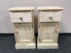 A pair of light pine pot cupboards,