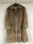 A lady's musquash fur coat, retailed by Maurice Velody (Furs) Ltd, Park Lane,
