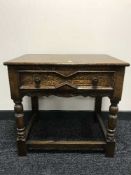 An oak side table fitted a drawer