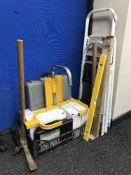 Two pairs of folding steps, wheel clamp with key, pick axe, sledge hammer,