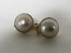 A pair of large mabe pearl earrings set in 18ct gold