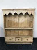 A pine plate rack fitted three drawers