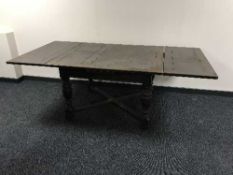 An early twentieth century oak pull-out dining table
