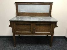 An Edwardian oak marble topped washstand