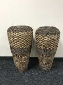 A large pair of terracotta and wicker vases