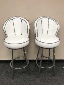 A pair of white leather and chromed bar stools (2)