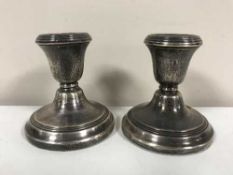 A pair of silver dwarf candlesticks,