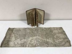 An antique map of London and an antique leather bound volume book of fairs published by the Kings