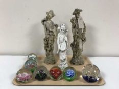 A tray of three oriental figures and eight assorted glass paperweights