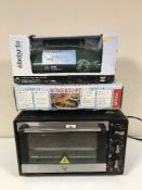 A Quest table top oven together with an Rumertopf oven dish and a boxed newspaper delivery box