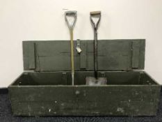 A large pine storage box containing hand tools