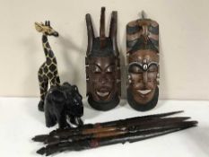 A crate of wooden figures, tribal masks,