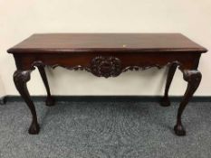 A Georgian style mahogany console table on claw and ball feet,