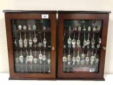 Two display cases containing a quantity of assorted crested spoons