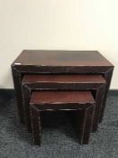 A set of three graduated leather tables and a coffee table