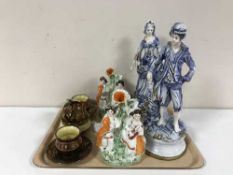 A pair of early 20th century pottery figures, pair of Staffordshire spill vases,