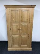 A pine double door hanging wardrobe