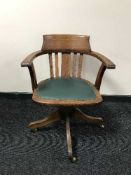 An oak swivel captain's armchair