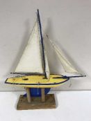 A Star Yacht pond yacht on wooden stand