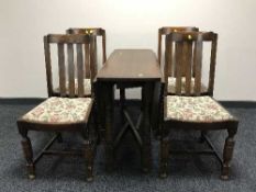 An oak gate leg table and four oak chairs