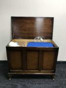 An oak blanket box containing linen, wool blanket,