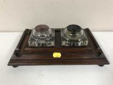 A late Victorian mahogany desk stand with two glass inkwells