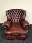 A red button leather Chesterfield armchair