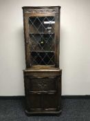 A carved oak leaded door corner display cabinet