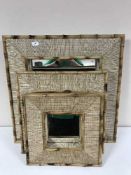 A set of three graduated bamboo framed mirrors