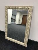 A decorative gilt framed overmantel mirror