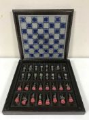 A chess set with pewter playing pieces