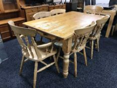 A pine farmhouse dining table and six chairs