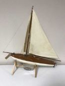 A model pond yacht together with two early 20th century prints on glass depicting HMS Lion and the