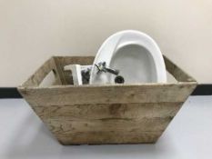 A pine box containing two ceramic basins