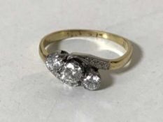 An 18ct gold three stone diamond crossover ring