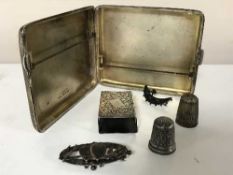 A group of silver to include cigarette case, matchbox holder, two thimbles,