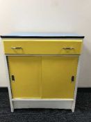 A melamine topped kitchen cabinet
