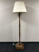 A mahogany standard lamp and shade