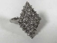 A diamond cluster ring, set with 29 brilliant-cut diamonds in a marquise setting,