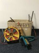 A box containing Black and Decker chain saw, hand tools,