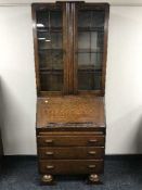 An oak glazed door bureau bookcase