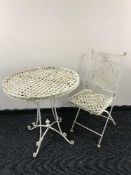 A circular folding patio table with chair