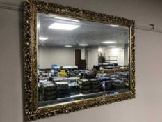 An ornate gilt framed bevelled mirror