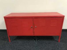 A red storage locker with key and similar two door cabinet
