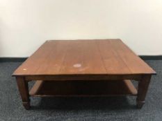 A large contemporary pine two tier square coffee table